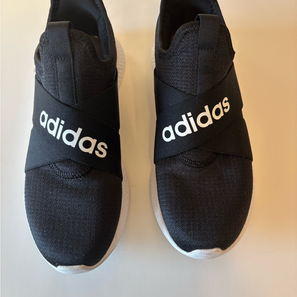 Adidas Black and white slip on sneakers.